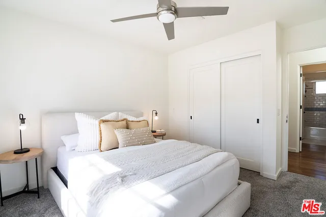 a bedroom with a bed and a night stand