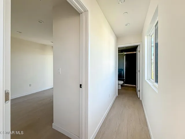 a view of a hallway with wooden floor