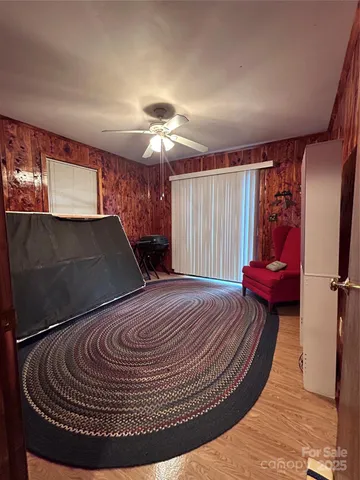 a view of a livingroom with furniture a ceiling fan and wooden floor