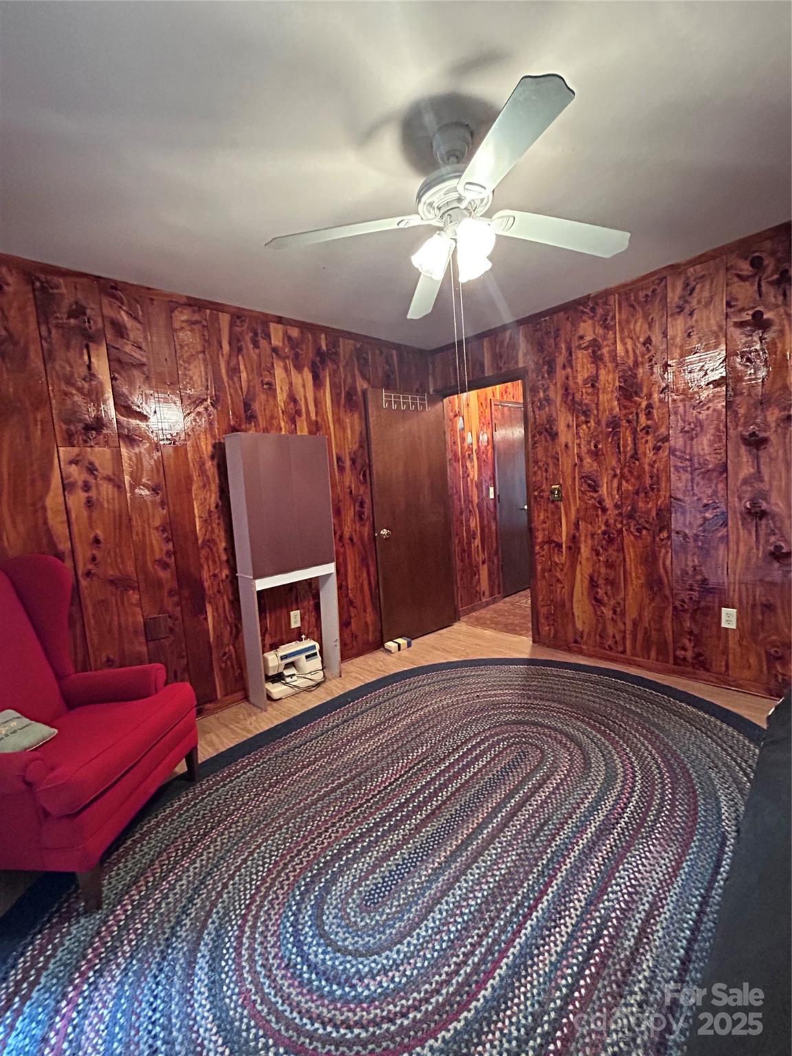 362 Melton Branch Road, Unit A1A6 Bakersville, NC 28705 - Photo 13 of 30 a view of a livingroom with furniture a ceiling fan and wooden floor