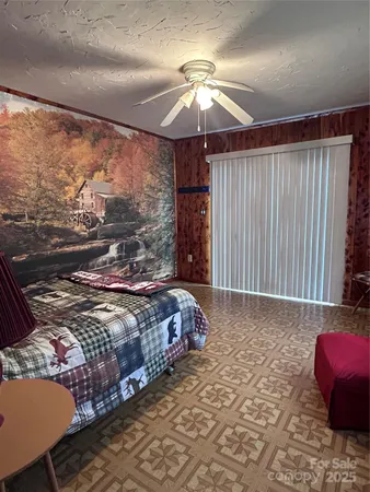 a bedroom with a bed couch and window