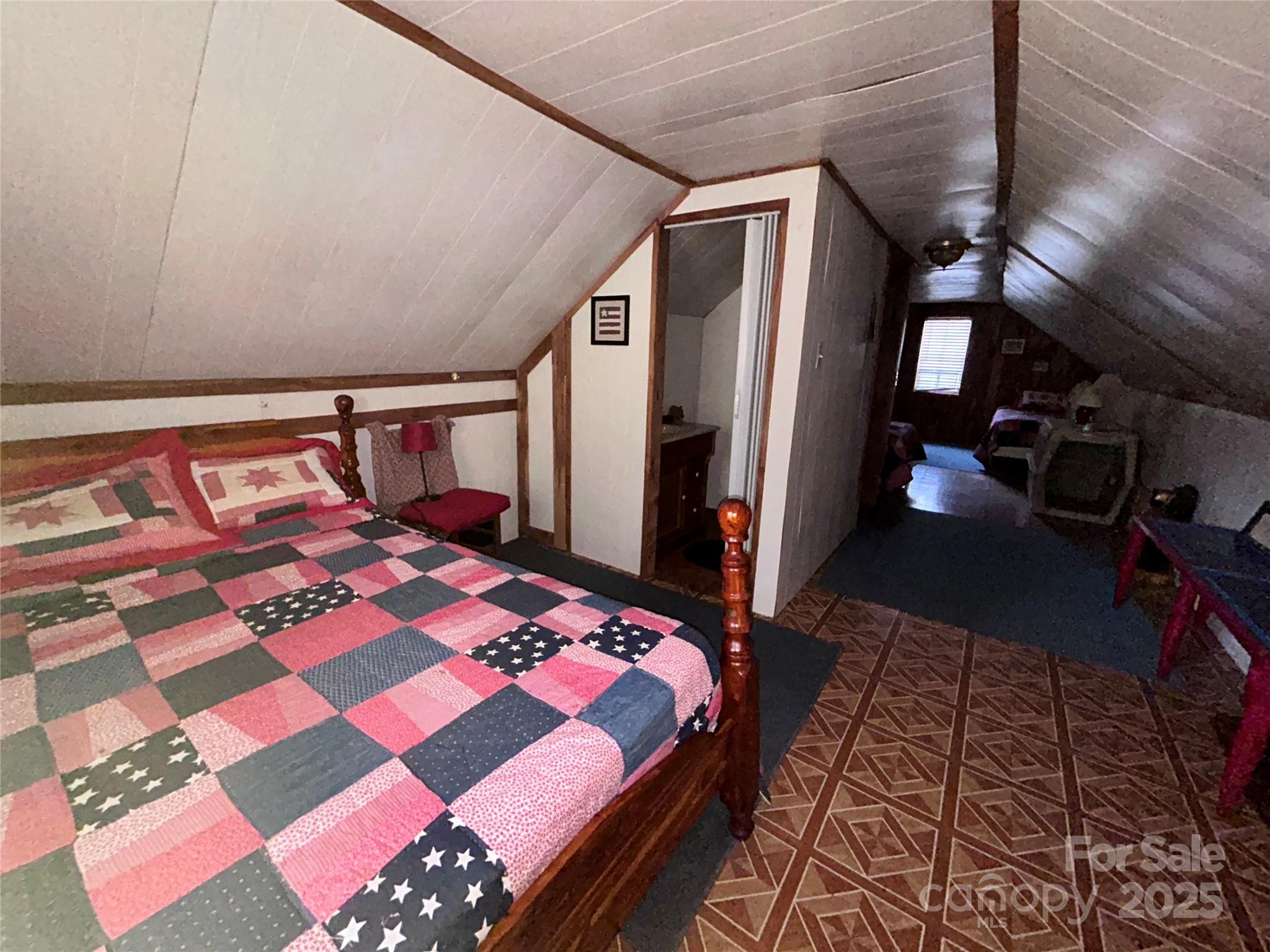 362 Melton Branch Road, Unit A1A6 Bakersville, NC 28705 - Photo 19 of 30 a bedroom with a bed and a table