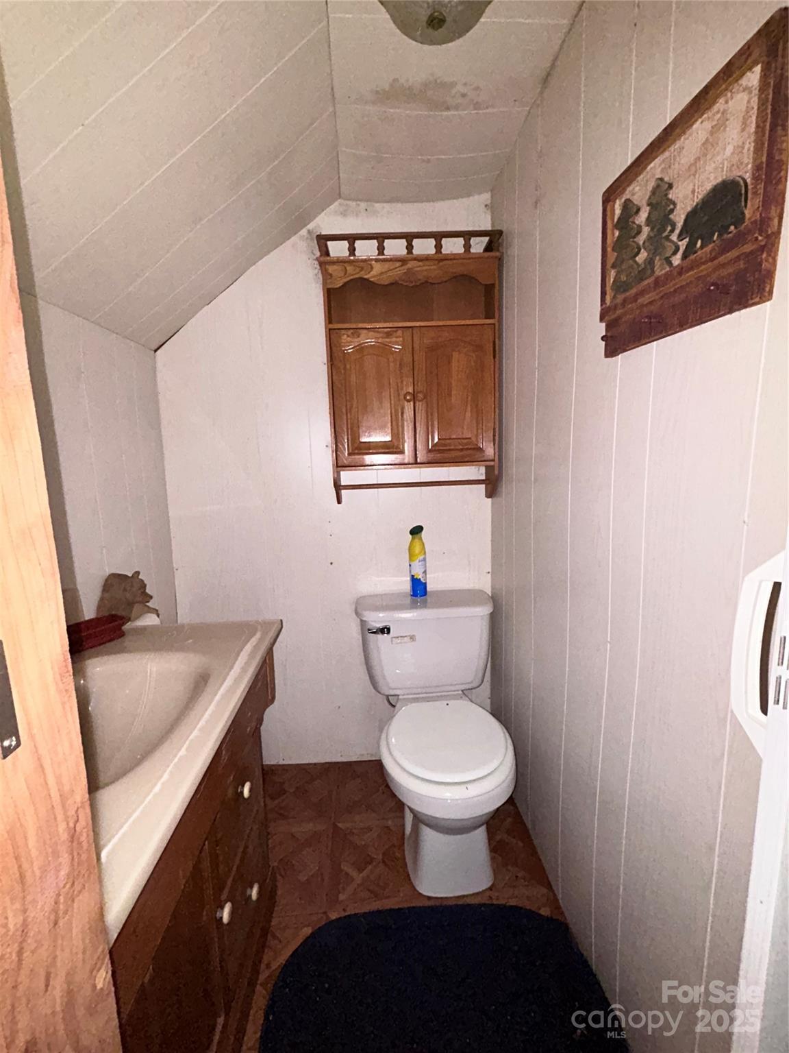 362 Melton Branch Road, Unit A1A6 Bakersville, NC 28705 - Photo 22 of 30 a bathroom with a granite countertop sink and a toilet