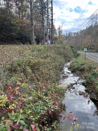 a view of a dirt road with trees in the background
