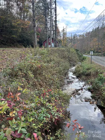 a view of a dirt road with trees in the background