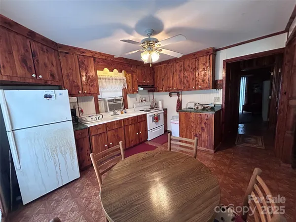 a kitchen with kitchen island granite countertop a sink cabinets and wooden floor