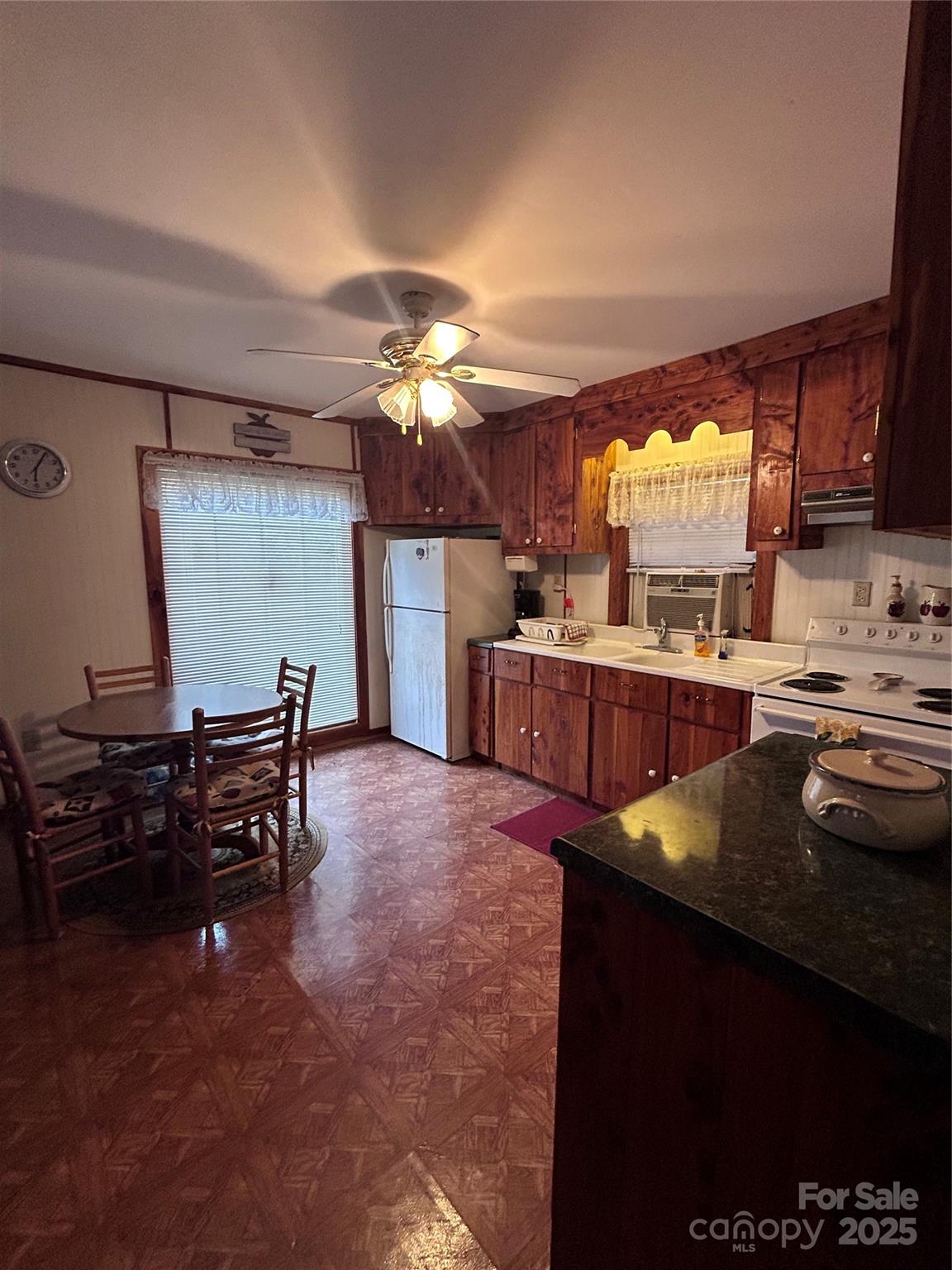 362 Melton Branch Road, Unit A1A6 Bakersville, NC 28705 - Photo 9 of 30 a kitchen with kitchen island granite countertop a sink cabinets and wooden floor