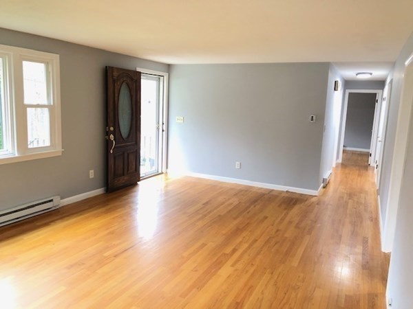 4 Kingsbury Road Webster, MA 01570 - Photo 4 of 22 an empty room with wooden floor and windows