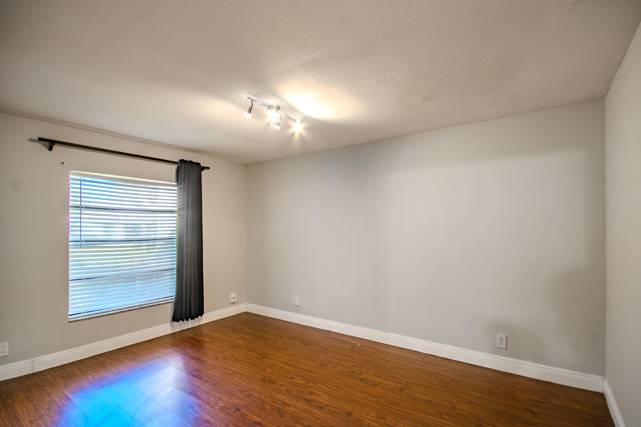 427 Cottonwood Place Boca Raton, FL 33431 - Photo 11 of 30 a view of empty room with wooden floor and fan