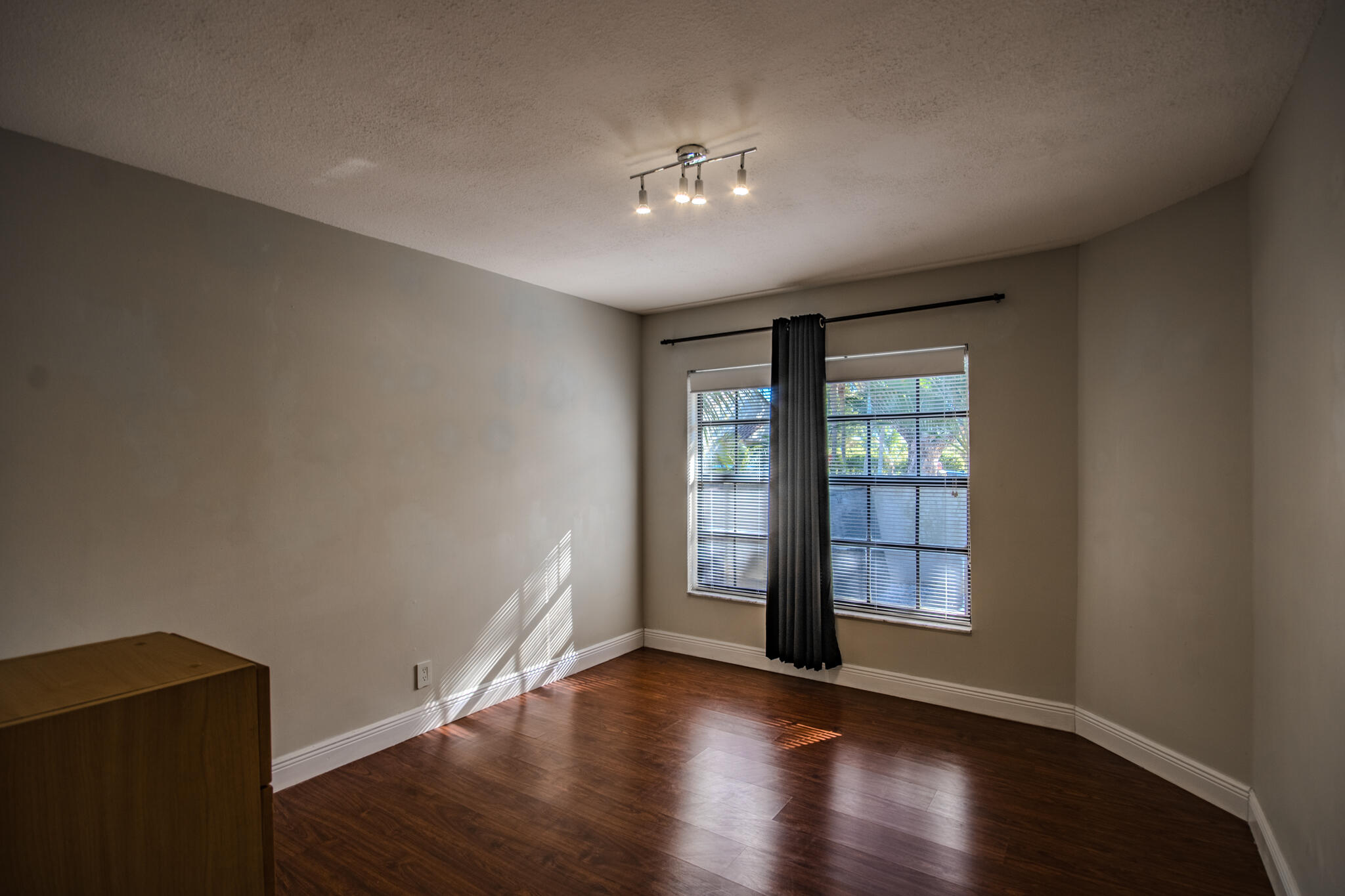 427 Cottonwood Place Boca Raton, FL 33431 - Photo 21 of 30 a view of an empty room with wooden floor and a window