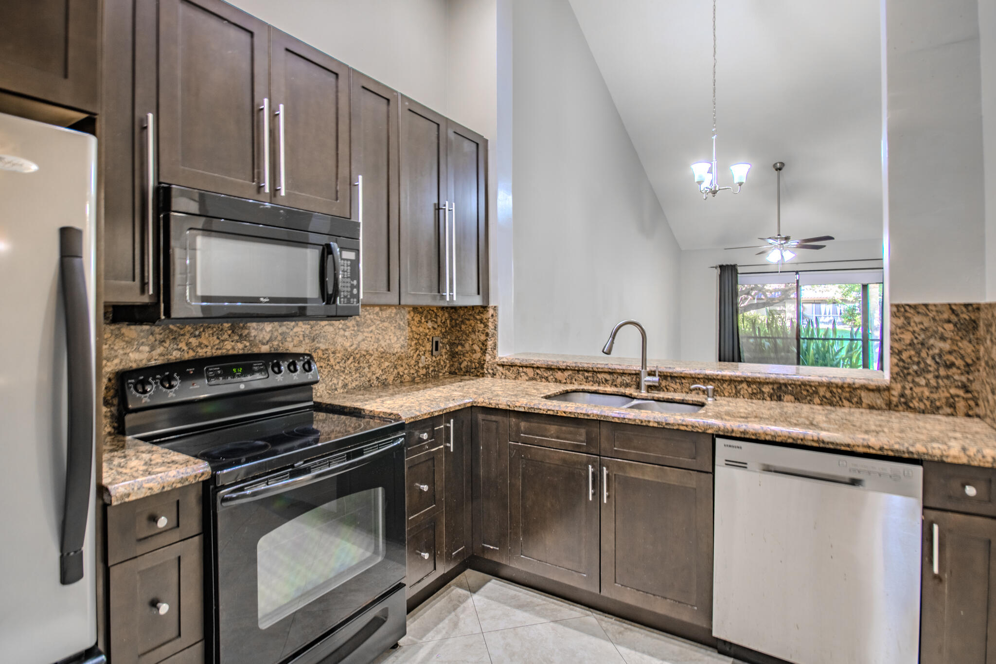 427 Cottonwood Place Boca Raton, FL 33431 - Photo 6 of 30 a kitchen with stainless steel appliances granite countertop a sink stove and microwave