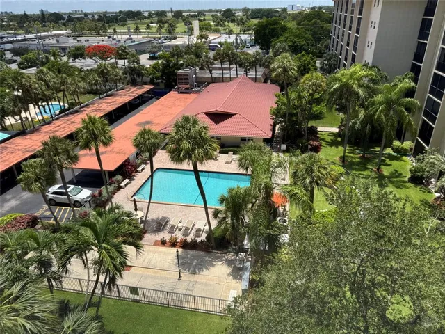 an aerial view of a house with a garden and lake view