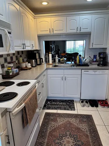 a kitchen with a stove a sink and a refrigerator
