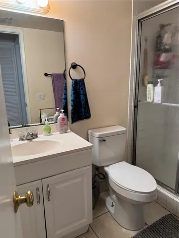 a bathroom with a sink mirror vanity and toilet