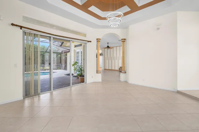 a living room with furniture and kitchen view