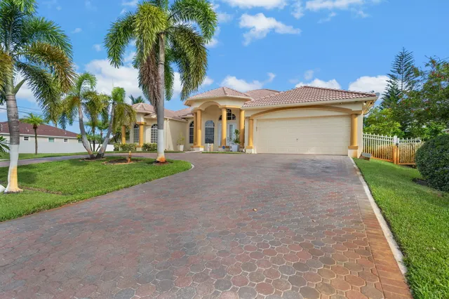 a front view of house with yard and green space
