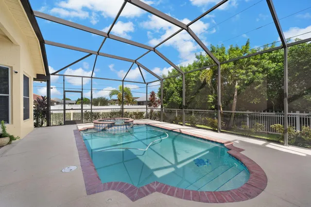 a view of a backyard with swimming pool