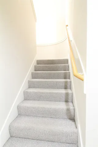 a view of staircase with white walls