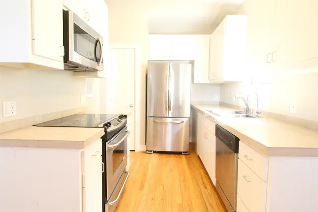 a kitchen with a sink a refrigerator and a stove