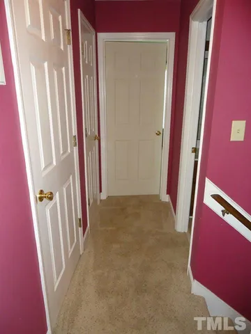 a view of a livingroom with wooden floor and stairs