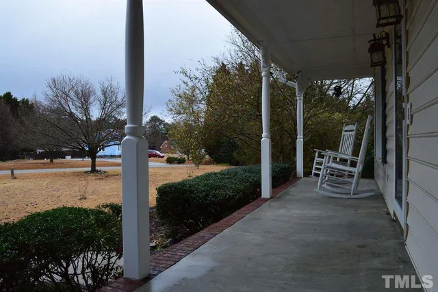 a view of a chair and tables in the patio