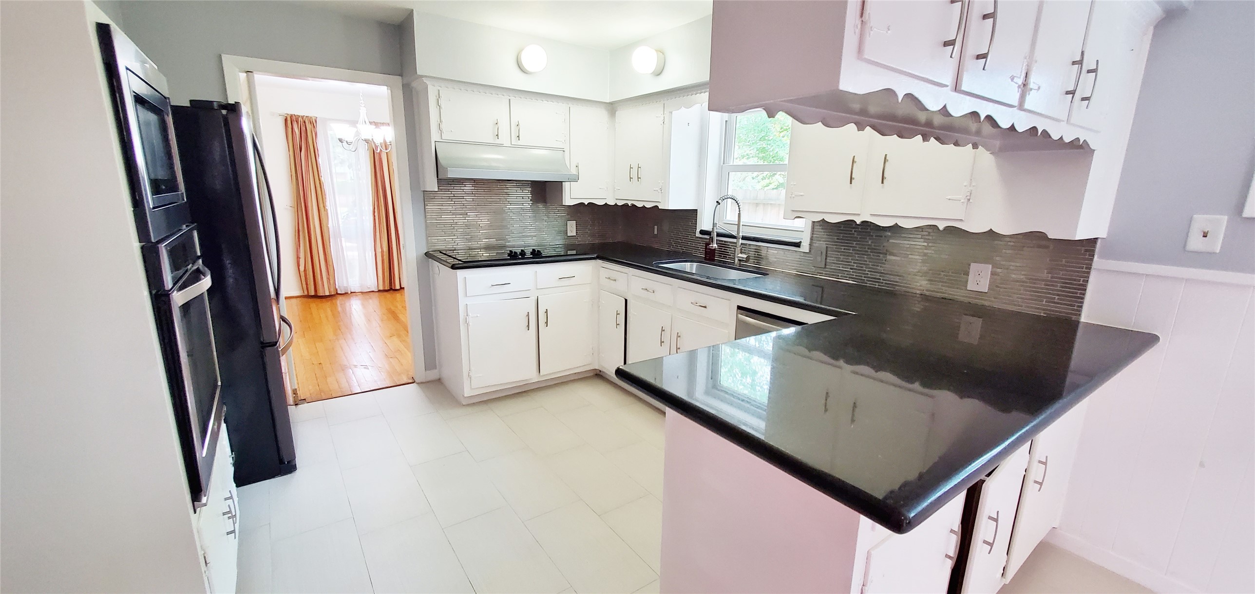 5630 Edith Street Houston, TX 77081 - Photo 6 of 30 Refrigerator included. Kitchen with granite counter tops.