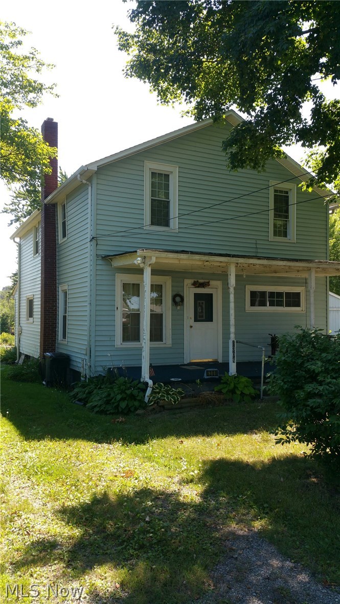 6308 Wayland Road Ravenna, OH 44266 - Photo 2 of 22 View looking east from Wayland Road showing the front porch, central air conditioner condenser on left side of house.