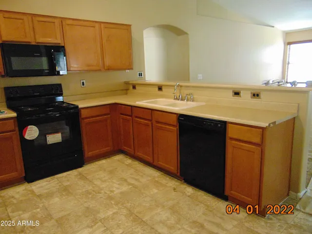 a kitchen with a refrigerator and a sink