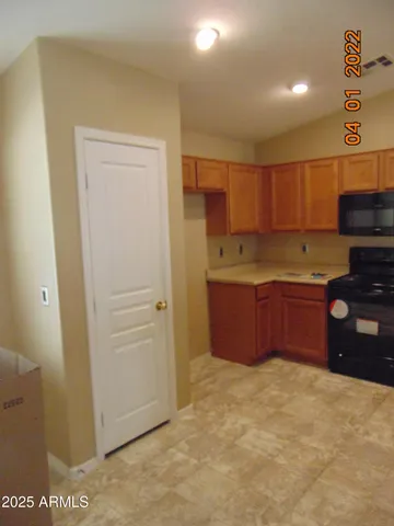 a kitchen with kitchen island a stove top oven a sink and a refrigerator