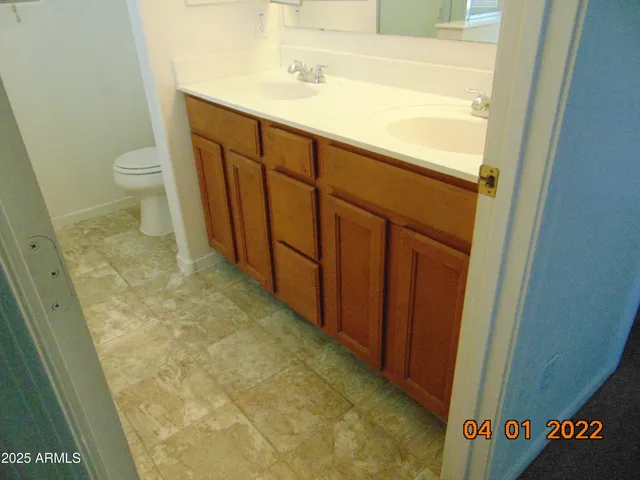 a bathroom with a sink a toilet and mirror