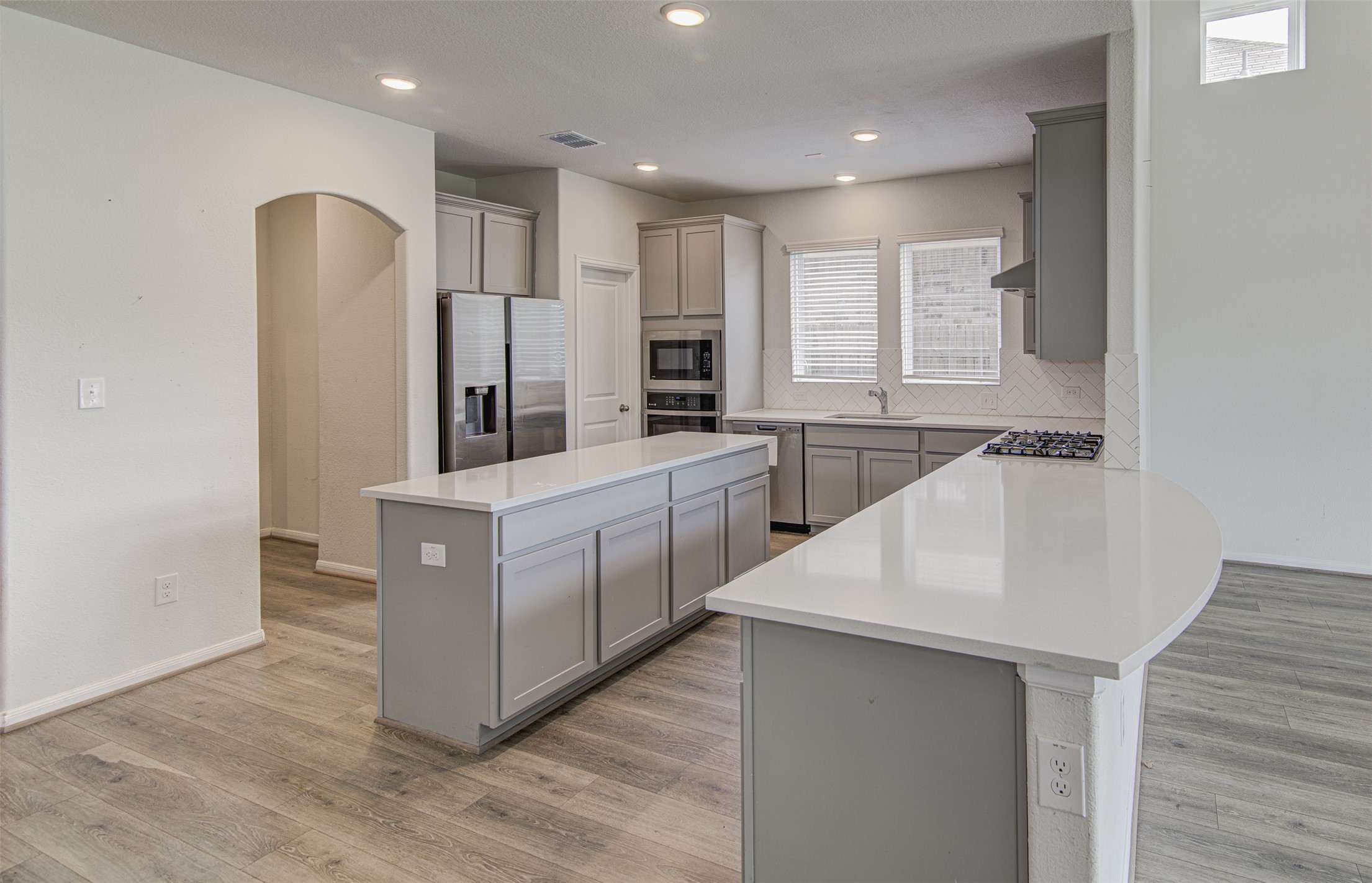 774 Cherrystone Loop Buda, TX 78610 - Photo 7 of 38 A contemporary kitchen features sleek countertops, modern cabinetry, and recessed lighting.