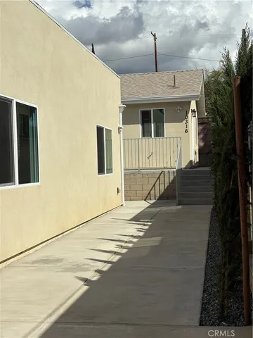 a kitchen with stainless steel appliances granite countertop a sink a stove and a wooden floor