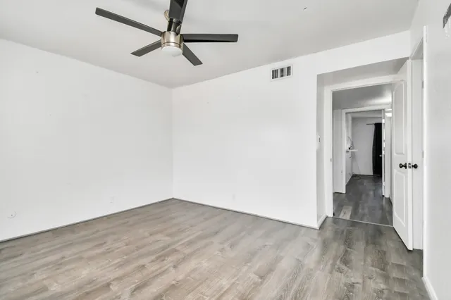 a view of a hallway with wooden floor