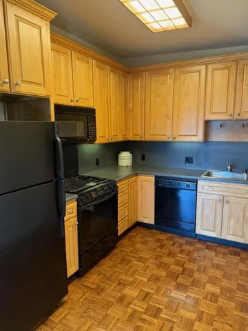 a stove top oven sitting inside of a kitchen