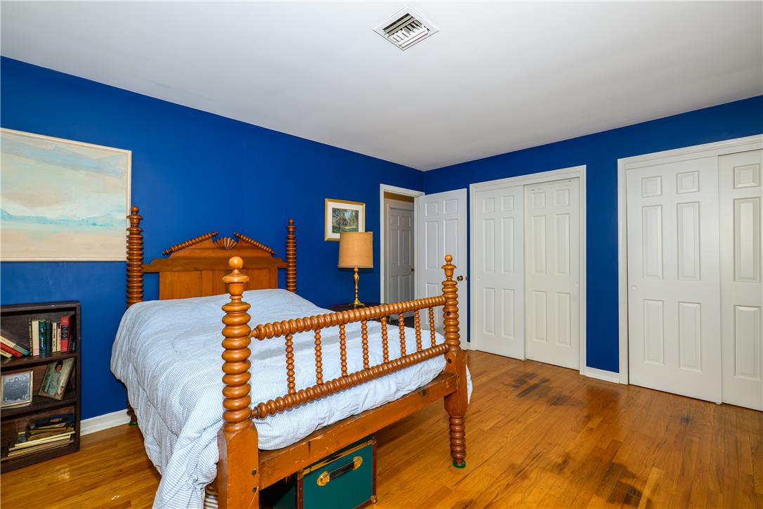 2516 Rachael Lane Orefield, PA 18069 - Photo 23 of 45 Well-lit sleeping quarters with rich hardwood flooring and a classic wooden bed frame.