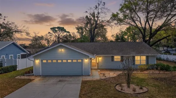 a front view of a house with a yard and a garage