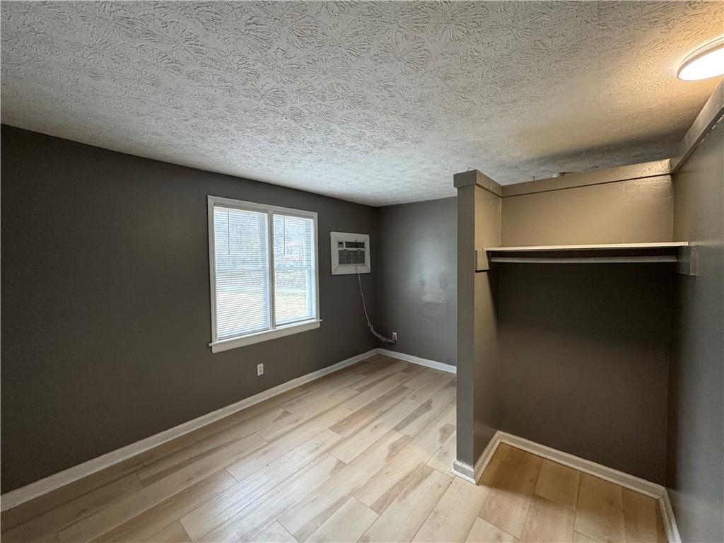 1410 Cave Spring Road Southwest Rome, GA 30161 - Photo 12 of 13 an empty room with wooden floor and windows