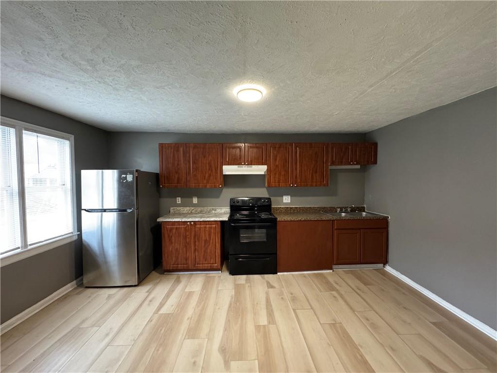 1410 Cave Spring Road Southwest Rome, GA 30161 - Photo 10 of 13 a kitchen with a refrigerator stove and oven