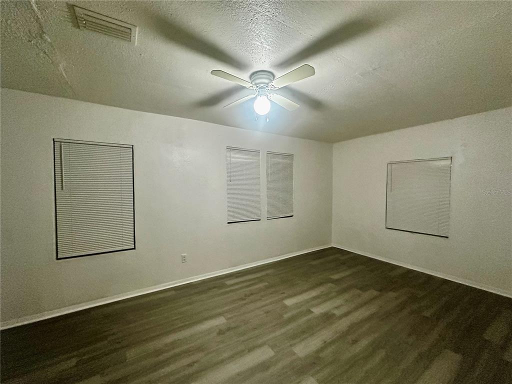 1907 Rio Grande Avenue Orlando, FL 32805 - Photo 10 of 17 an empty room with wooden floor and windows
