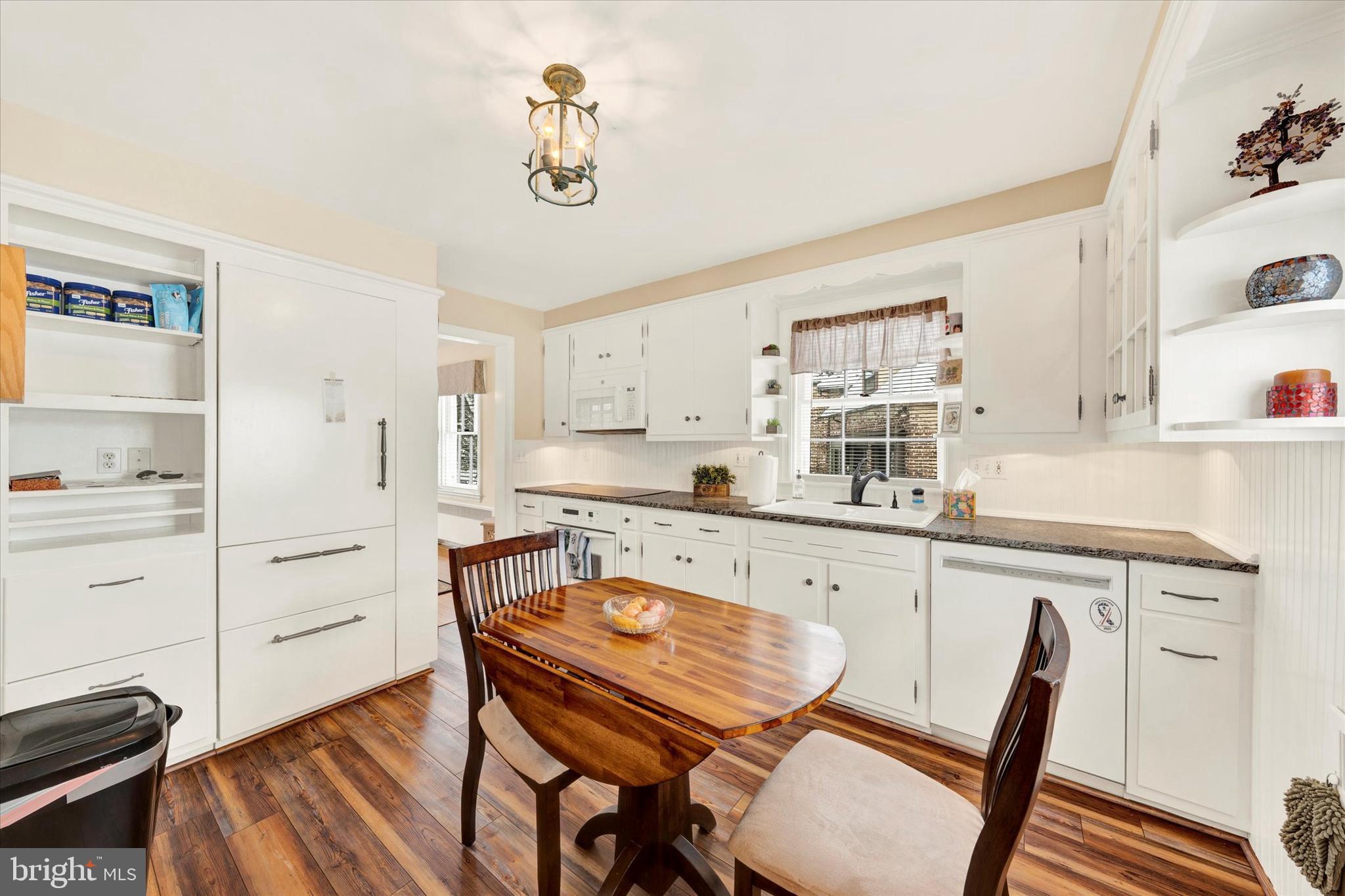 1406 Farr Road Reading, PA 19611 - Photo 10 of 29 a kitchen with a dining table chairs and white cabinets