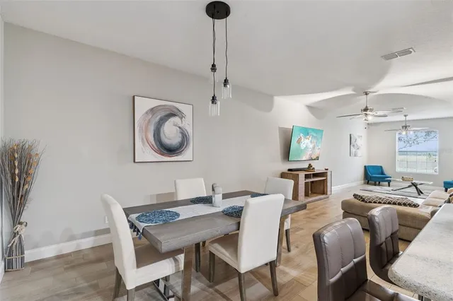 a view of a dining room with furniture and chandelier
