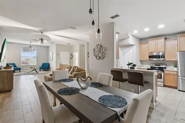 a living room with furniture and kitchen view