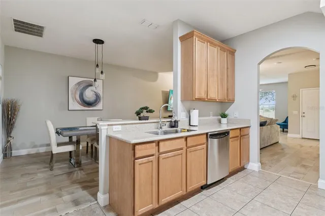 a kitchen with a sink window and cabinets