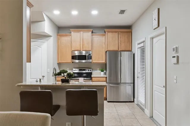 a kitchen with stainless steel appliances a refrigerator stove microwave and cabinets