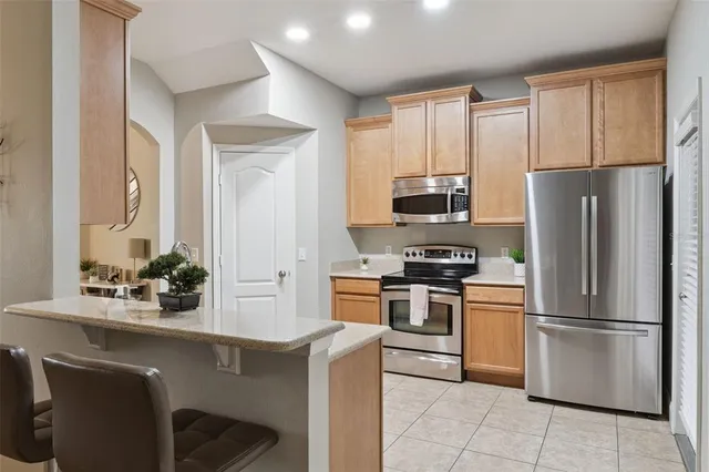 a kitchen with a refrigerator and a sink