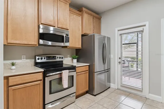 a kitchen with stainless steel appliances granite countertop a refrigerator stove and microwave