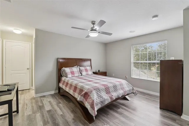 a bedroom with a large bed and a chandelier