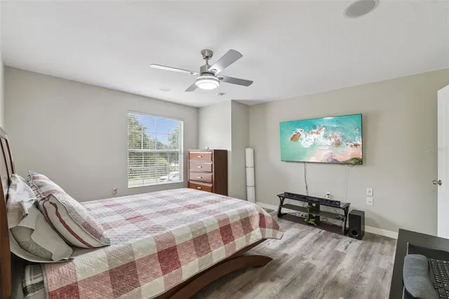 a bedroom with a bed a couch and a window