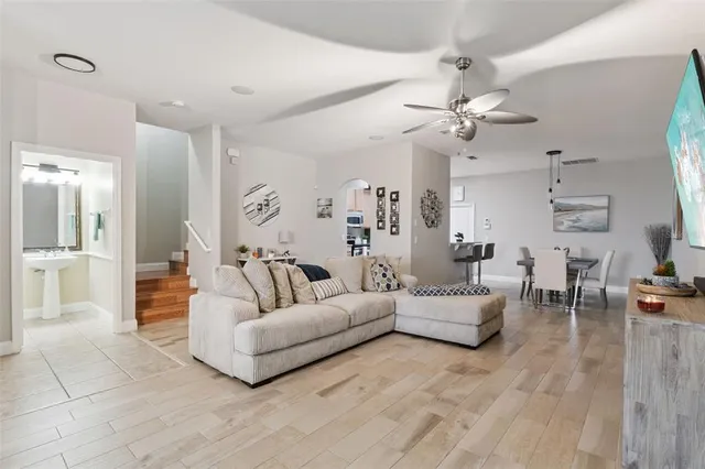a living room with furniture a chandelier and a rug
