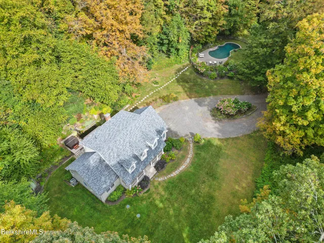 an aerial view of a house with a yard